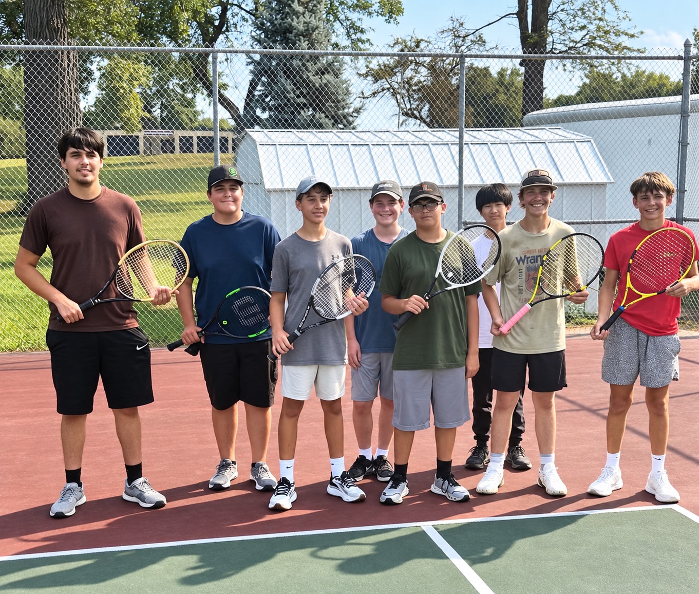 Kids at South Sioux City Community School holding rackets sent by Second Serve MetroWest